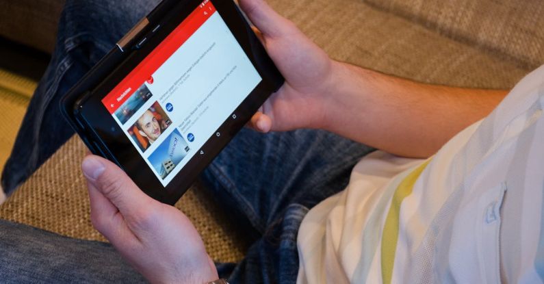 YouTube - Person Holding Tablet Computer Showing Videos