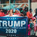 Campaign - Woman Holding Trump Keep America Great Again 2020 Banner